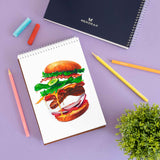 Drawing a burger with oil pastel, pencil colours and acrylic colour using Menorah's A5 size 115 gsm sketchbook.