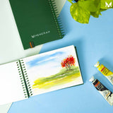 Nature scenery tree watercolor painting on A6 size watercolor sketchbook is the best travel accompanion for the creators. Watercolor sketchbook is made of 100% cotton and is 100% Vegan. It contains 40 pages with a 300GSM Thickness so that watercolor won't penetrate to the other page. It is covered by Metal spiral with 360 Degree easy turn. Make your creations by using watercolour paintings, Acrylics, Gouache, Tempera, Poster colour in this sketchbook. Bright Blue color sketchbook